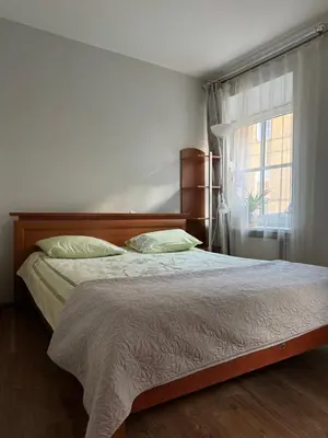 a bedroom with a bed and a window at Danarent Tilto in Vilnius