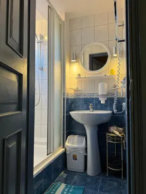 a bathroom with a sink and a toilet and a mirror at Danarent Tilto in Vilnius