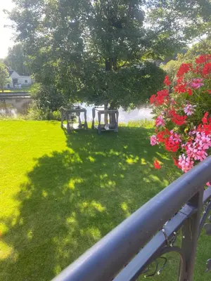 a view of a park with benches and flowers at Gulbės Apartamentai in Anykščiai