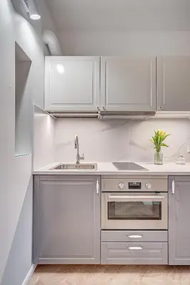 a kitchen with white cabinets and a sink at Angel House Vilnius, 47 in Vilnius
