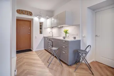 a kitchen with two chairs and a sink and a counter at Angel House Vilnius, 47 in Vilnius