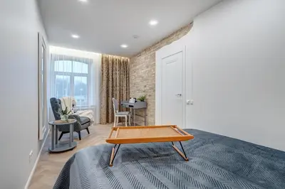 a bedroom with a bed with a coffee table on it at Angel House Vilnius, 47 in Vilnius