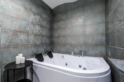 a bathroom with a white tub in a room at Old Town Jacuzzi in Vilnius