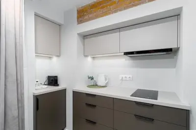 a kitchen with a white counter top and a microwave at Old Town Jacuzzi in Vilnius