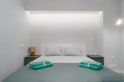 a bedroom with a bed with two pillows on it at Old Town Jacuzzi in Vilnius