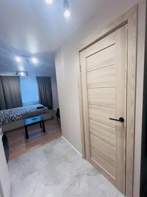 a room with a door with a bed in the background at studio apartment in Vilnius
