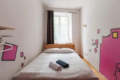 a bedroom with a bed with two towels on it at Pogo Hostel in Vilnius