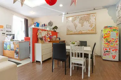 a kitchen and dining room with a table and a refrigerator at Pogo Hostel in Vilnius