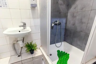 a bathroom with a shower and a sink and a shower at Pogo Hostel in Vilnius