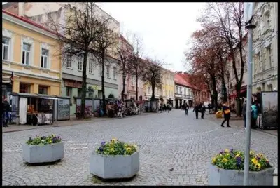 a city street with people walking down the street at Pogo Hostel in Vilnius