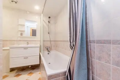 a bathroom with a tub and a sink and a shower at Old town apartment with 3 bedrooms by URBAN RENT in Vilnius