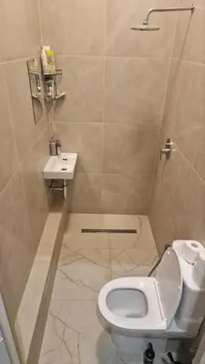 a bathroom with a toilet and a sink at Kaunas Studios - RentA 18 in Kaunas