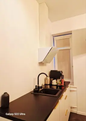 a kitchen with a sink and a counter top at Kaunas Studios - RentA 18 in Kaunas