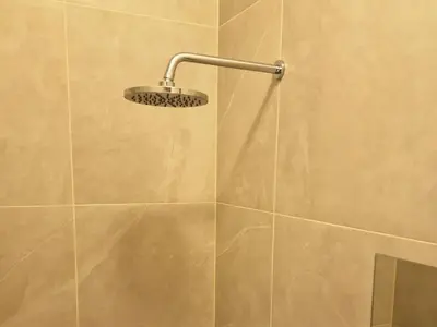 a shower with a shower head in a bathroom at Kaunas Studios - RentA 19 in Kaunas