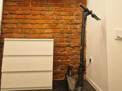 a vacuum against a brick wall next to a brick wall at Kaunas Studios - RentA 19 in Kaunas