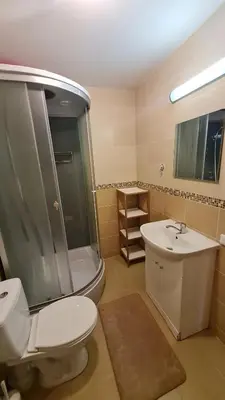 a bathroom with a toilet and a shower and a sink at Švitrigailos gatvėje 1kambario butas naujos statybos name in Vilnius