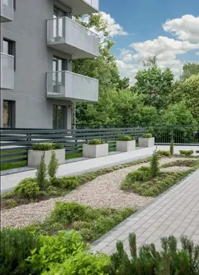 a courtyard in front of a building with a balcony at Švitrigailos gatvėje 1kambario butas naujos statybos name in Vilnius