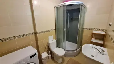 a bathroom with a shower and a toilet and a sink at Švitrigailos gatvėje 1kambario butas naujos statybos name in Vilnius
