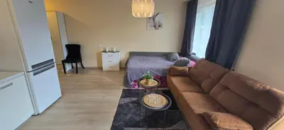 a living room with a couch and a table at Švitrigailos gatvėje 1kambario butas naujos statybos name in Vilnius