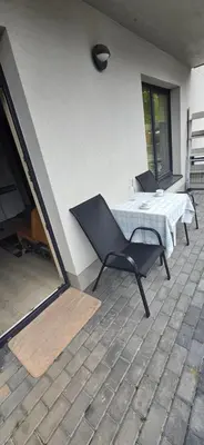 a patio with a table and chairs on a patio at Švitrigailos gatvėje 1kambario butas naujos statybos name in Vilnius
