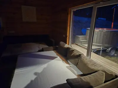 a living room with a couch and a window at Tauro Pirtis in Vainiūnai