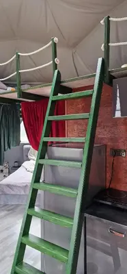 a ladder leading up to a bunk bed in a tent at Rojus dviems in Žaugėdai