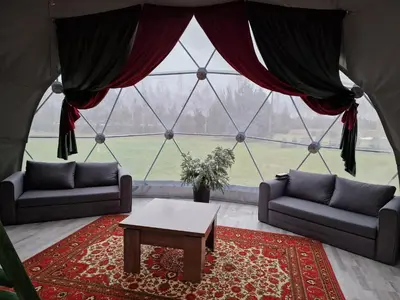 a living room with two couches and a table at Rojus dviems in Žaugėdai