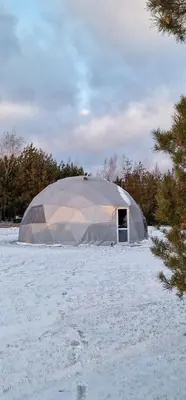 a large tent in a field covered in snow at Rojus dviems in Žaugėdai