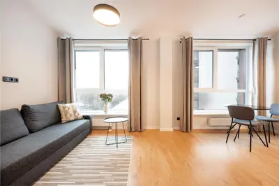 a living room with a couch and a table at Youston self check-in apartments Vilnius in Vilnius