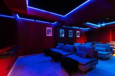 a living room with blue and red lighting and couches at Youston self check-in apartments Vilnius in Vilnius