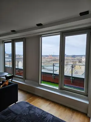 a room with windows with a view of a city at Skyline Pearl Vilnius in Vilnius