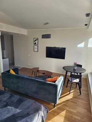 a living room with a couch and a table at Skyline Pearl Vilnius in Vilnius