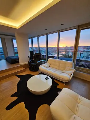 a living room with a couch and a table at Skyline Pearl Vilnius in Vilnius