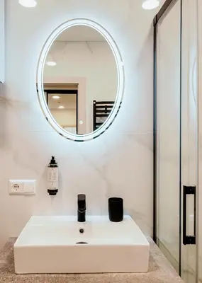 a bathroom with a white sink and a mirror at King Mindaugas center apartment in Kaunas