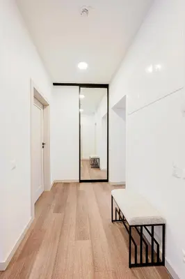 an empty hallway with a bench and a mirror at King Mindaugas center apartment in Kaunas