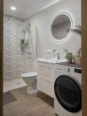 a bathroom with a sink and a washing machine at Lake Town Apartment in Vilnius