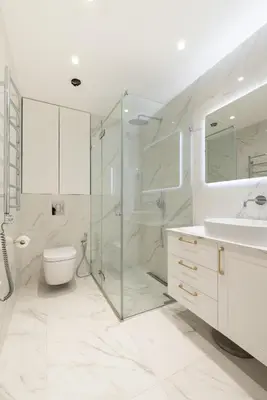 a bathroom with a shower and a toilet and a sink at The Zen Den Apartment in Uzupis in Vilnius