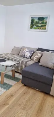 a living room with a couch and a coffee table at Šiauliai Central Vytauto Apartment in Šiauliai