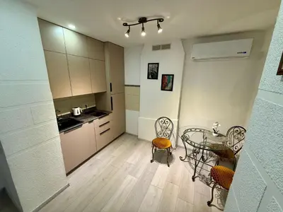 a kitchen with a table and chairs in a room at Šopeno Old Town Apartments in Vilnius