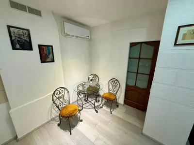 a dining room with a table and two chairs at Šopeno Old Town Apartments in Vilnius
