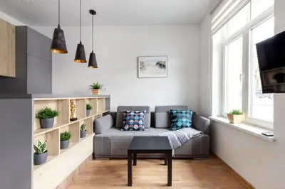 a living room with a couch and a table at Cosy Central Apartments by Reside Baltic in Vilnius