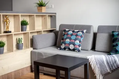 a living room with a couch and a table at Cosy Central Apartments by Reside Baltic in Vilnius