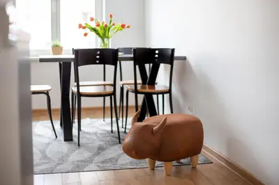 a dining room with a table with chairs and a pig toy at Cosy Central Apartments by Reside Baltic in Vilnius