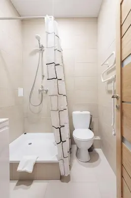 a bathroom with a tub and a toilet and a shower at Cosy Central Apartments by Reside Baltic in Vilnius