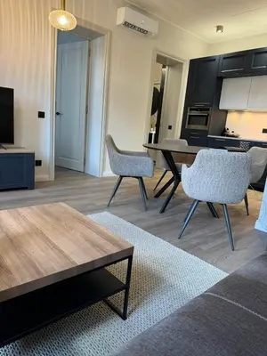 a living room with a table and chairs at Rambynas R36 in Panevėžys