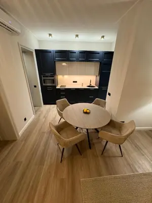 a living room with a table and two chairs at Rambynas R36 in Panevėžys