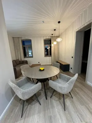 a living room with a table and chairs and a couch at Rambynas R36 in Panevėžys