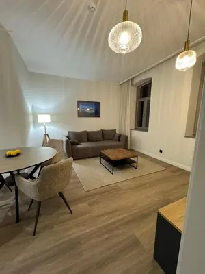 a living room with a couch and a table at Rambynas R36 in Panevėžys