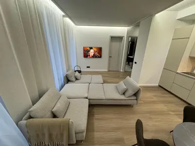 a living room with two couches and a tv at Rambynas R36 in Panevėžys