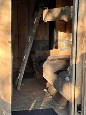a wooden bunk bed in a wooden building at Terra Gratia - namukas Natūralistas in Nemeikšiai